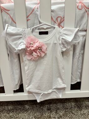 White Ruffle-Sleeve One-Piece with Pink Flower Accent